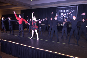 Dancers on stage posing for big finish of a dance number